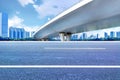 Asphalt roads and city buildings under the overpass, automobile advertising road material.